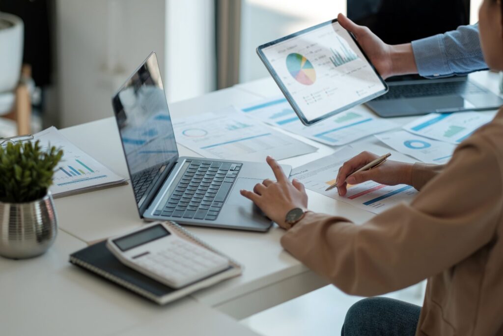 A person sits at a desk with their laptop, working on an ESOS action plan.
