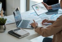 What makes a good ESOS action plan? A person sits at a desk with their laptop, working on an ESOS action plan.