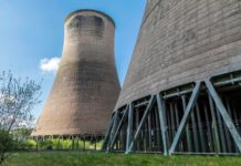 UK rockets nuclear forward with £196m investment Looking up at two nuclear reactors from below. A plant in Cheshire will receive funding from the government.