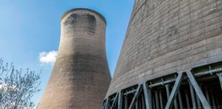 UK rockets nuclear forward with £196m investment Looking up at two nuclear reactors from below. A plant in Cheshire will receive funding from the government.