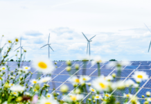 Great British Energy: Will it cut bills and speed up net zero? A solar panel and wind turbines in the english countryside, a key factor in the Labour's plan for Great British Energy