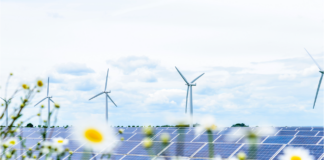 Great British Energy: Will it cut bills and speed up net zero? A solar panel and wind turbines in the english countryside, a key factor in the Labour's plan for Great British Energy