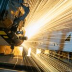 Including carbon capture in the ETS: consultation now open A machine in a manufacturing company lets off a large, bright flurry of sparks.