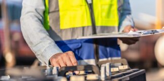 Battery storage: What role will it play in the UK’s growing clean energy mix? A man in a hi-vis vest is adjusting battery storage