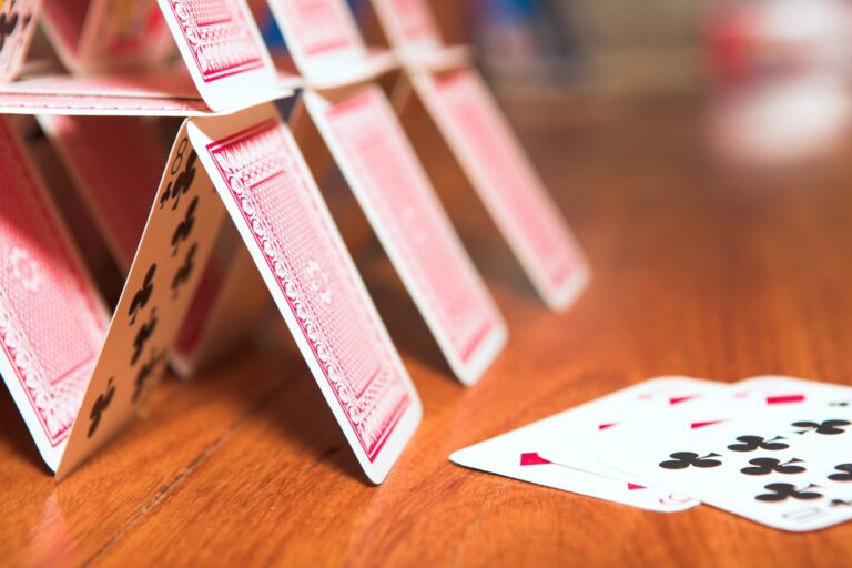 A house of cards on a brown table, which may be symbolic of the government's BECCs strategy, according to the article.