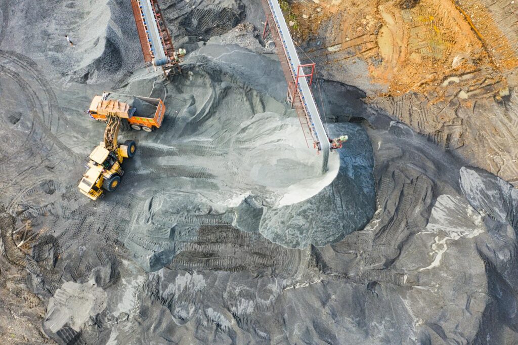 An orange tractor works on-site at a coal mine