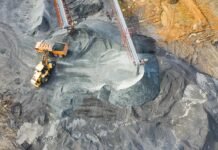 New coal mining licenses to end as UK government prioritises clean energy An orange tractor works on-site at a coal mine