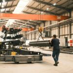 UK Government launches Steel Council to secure industry’s low-carbon future A man works in a manufacturing warehouse moving steel.