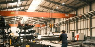 UK Government launches Steel Council to secure industry’s low-carbon future A man works in a manufacturing warehouse moving steel.