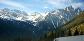 Understanding transition plans in the UK and their role in net zero A large white truck drives along a road in front of a mountain range