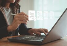 ESOS: New template for Progress Update submissions A woman sits at her laptop typing, with images of her screen projected in front of her