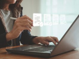 ESOS: New template for Progress Update submissions A woman sits at her laptop typing, with images of her screen projected in front of her