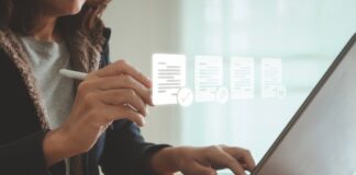 ESOS: New template for Progress Update submissions A woman sits at her laptop typing, with images of her screen projected in front of her