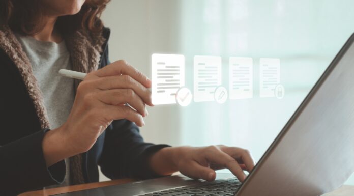 ESOS: New template for Progress Update submissions A woman sits at her laptop typing, with images of her screen projected in front of her