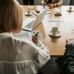New guidance released to align financial and climate transition plans A Woman in White Long Sleeve Shirt Writing on White Paper on Brown Wooden Table