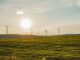 ISO and GHG Protocol announce partnership to harmonise carbon accounting standards Blue sky, green grass and wind turbines