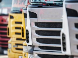 UK businesses offered up to £120,000 to switch to electric lorries close up view of the front grills of lorries, parked in a line