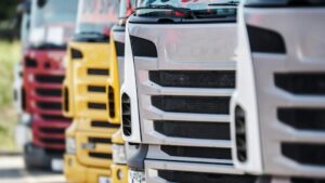 close up view of the front grills of lorries, parked in a line