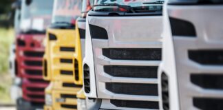 UK businesses offered up to £120,000 to switch to electric lorries close up view of the front grills of lorries, parked in a line