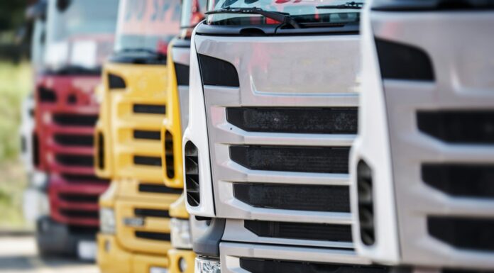 UK businesses offered up to £120,000 to switch to electric lorries close up view of the front grills of lorries, parked in a line